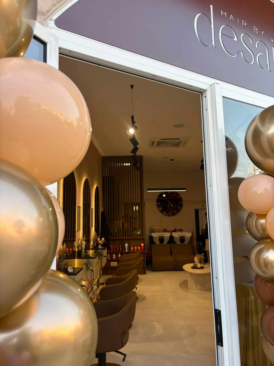 A glimpse into Hair by Desailee through the decorated salon entrance
