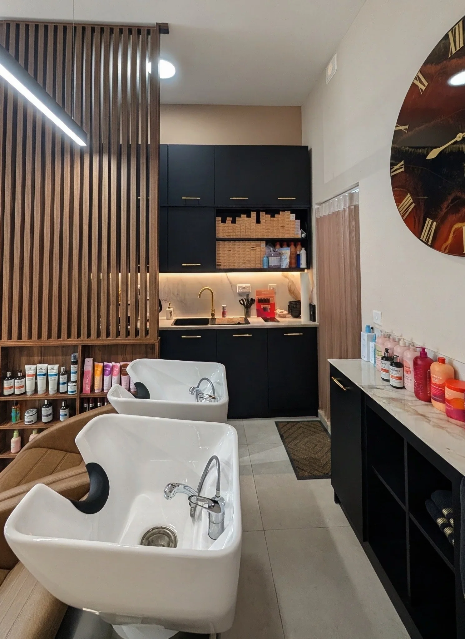 Wooden slat partition and black preparation kitchen