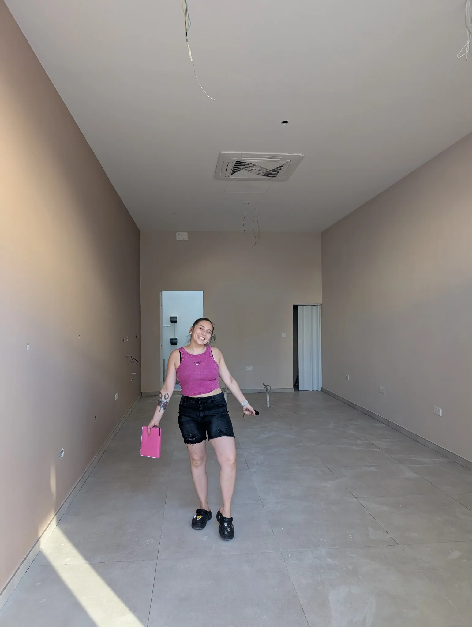 Desailee standing in the unfinished salon during the renovation