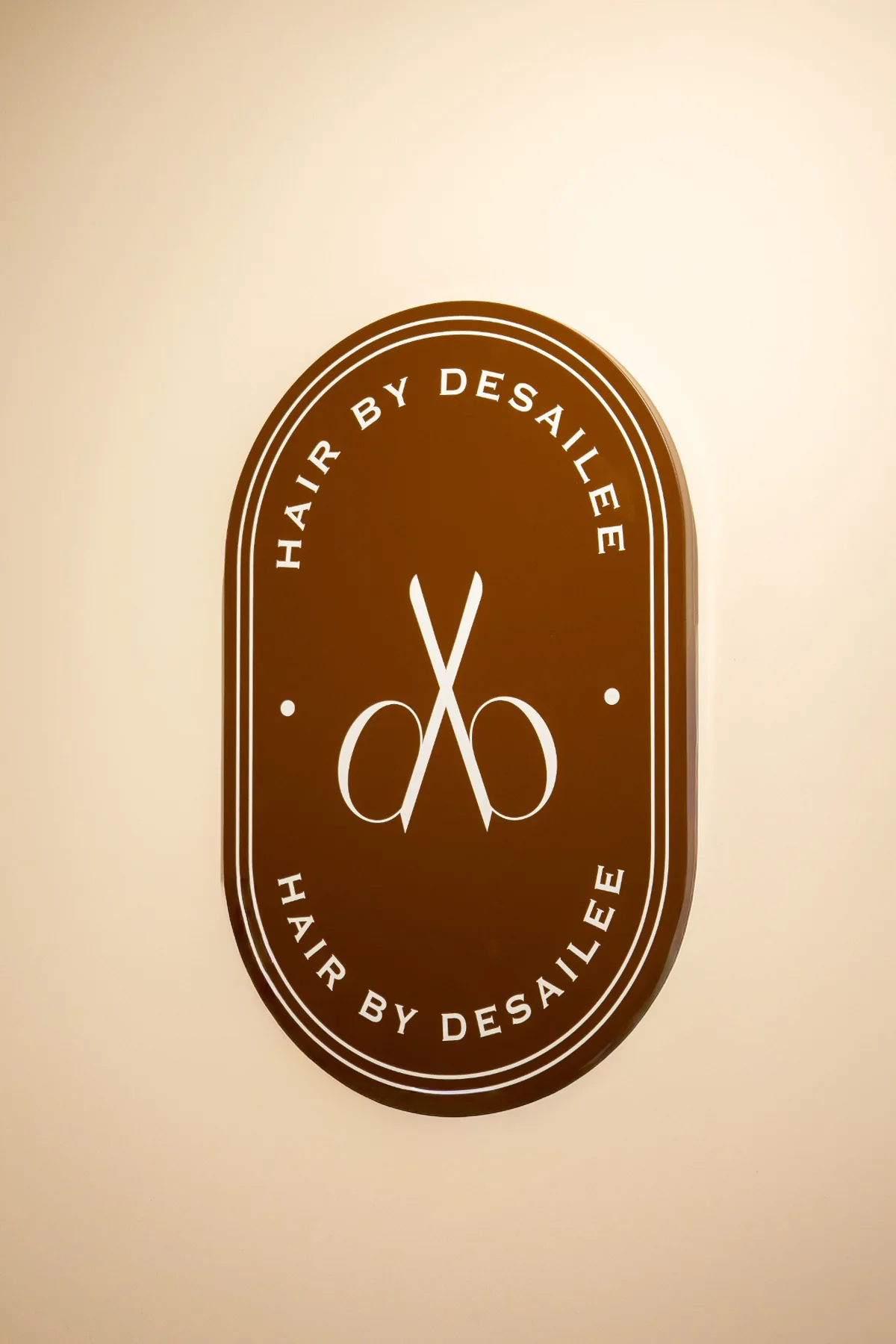Brown Hair by Desailee emblem displayed inside the salon